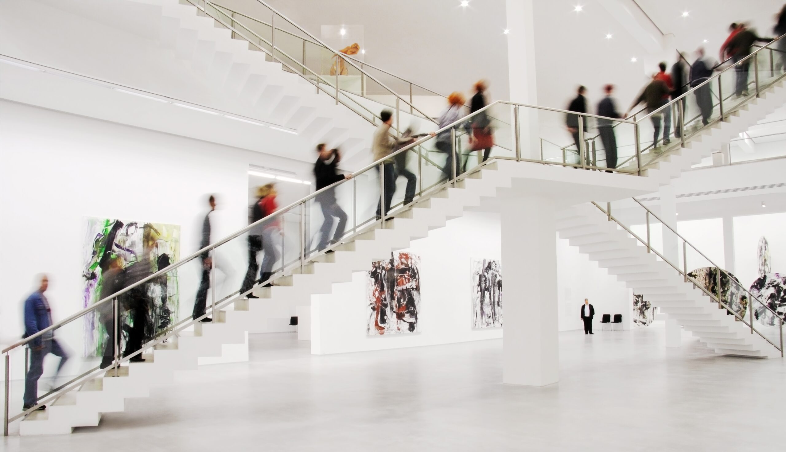 Interior staircase hall of the Berlinische Galerie with several people positioned on the steps